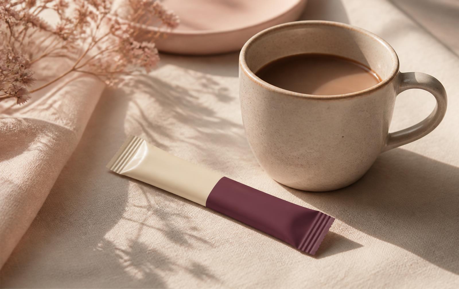 A Sanctum stick resting beside a morning cup of coffee on ivory linen